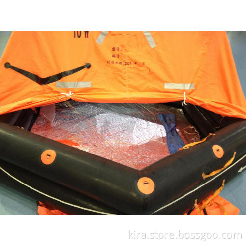 Self inflatable throw overboard life raft